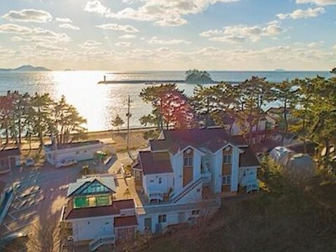 Sea and White Lighthouse Pension