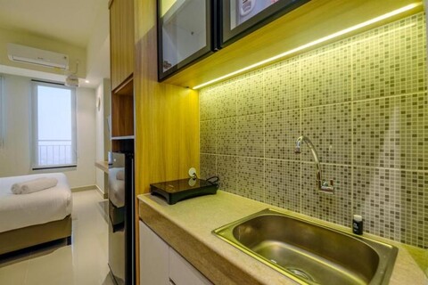 Fully Furnished with Modern Design Studio at Evenciio Apartment By Travelio